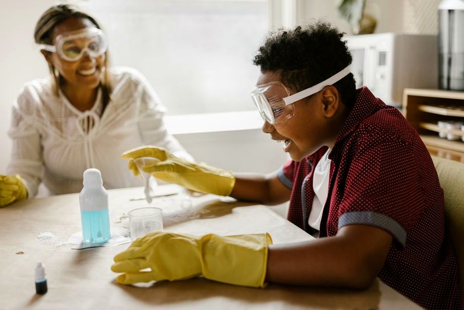 Two people sharing a hands-on activity at a bright table, reflecting the journal's interest in everyday learning and making.